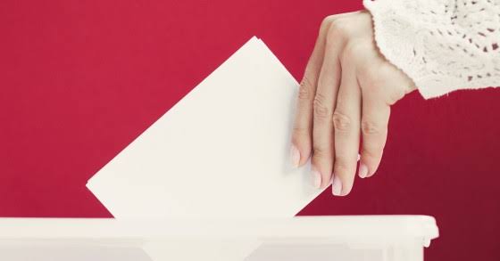 Hand posting a ballot into a box, Spain election 2026