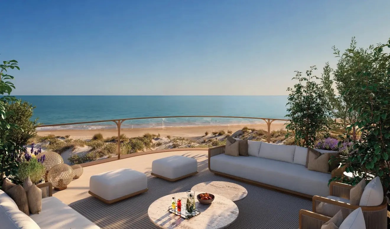St. Regis Marbella residence render: private terrace with sofas looking over the Real de Zaragoza dunes to the sea